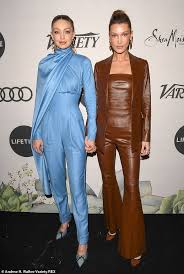 In november 2014, hadid made her debut in the top 50 models ranking at models.com. Gigi Hadid Stuns In Blue Satin Suit And Cape While Bella Rocks Brown Leather Couture Daily Mail Online