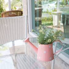 Set within a cylindrical clear glass vase, these artificial. Flowers Vase Decorated On Mirror Table At Living Room Artificial Stock Photo Picture And Royalty Free Image Image 44406604