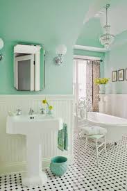 I loved the green and black combo with the natural wood blinds. 15 Stylish Bathroom Tile Patterns Domino Mint Green Bathrooms Green Bathroom House Of Turquoise