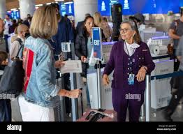 Los Angeles, CA April 20th: A Delta Customer Service Agent assists a  passenger in the newly