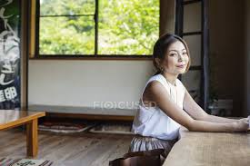 Japanese dining floor table for eating. Smiling Japanese Woman Sitting At A Table In A Japanese Restaurant Food Journey Stock Photo 325501440