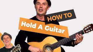 To hold the guitar simply tuck it under your elbow. How To Hold A Guitar Lesson 4 Beginner Guitar For Adults Youtube