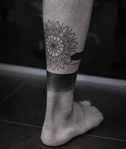Geometric/blackwork style piece on the right leg.