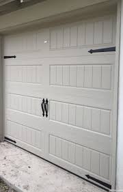 A Light Gray Steel Garage Door With Short Panel Pattern Also Uses Magnetic Garage Door Hardw Garage Doors Garage Door Hardware Garage Door Decorative Hardware