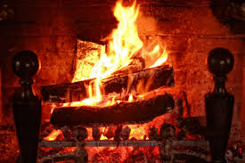 curled up with a book in front of a fire fireplace gas fireplace logs fireplace safety