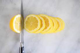 After you cut the lemon in two, slice each half into three wedges. How To Cut Citrus Fruit Garnishes For Cocktails