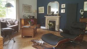 A blue accent wall anchors this blue and gray living room in an authentic farmhouse remodeled by chango and company. What Colours With Dark Blue Feature Wall Mumsnet