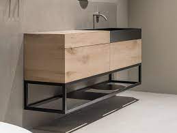 Dresscode è una collezione di mobili per bagno dalle linee contemporanee e dai solidi volumi accentuati dalla gola per l'apertura centrale in acciaio spazzolato e prevista in varie finiture. Less Vanity Unit By Moab80
