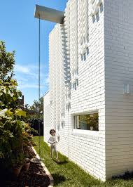 The style is modern while maintaining an lush native plants add softness and color to the facade of this contemporary california house. Atelier Red Black Built White Cascade House That Features Different Patterns Of Brick In Melbourne