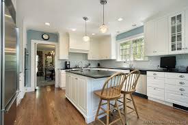 This gorgeous kitchen is fitted with dark gray kitchen cabinets, black hardware and matching black countertops. Grey Walls With Dark Wood Floors Novocom Top