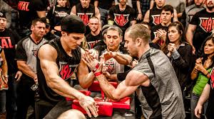 A tall female cop with a short man. How To Always Win At Arm Wrestling Gq