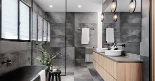 While choosing a light or dark tone of grey tile is fairly easy, getting the visual temperature right is trickier. A Cloudy Grey Tile Sets The Palette For This Bathroom