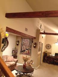 This chapel solves this issue by using a vertical wood cladding with a more substantial beam every few feet to mimic the look of a batten, but with a quieter and more extensive look. Need Ideas For Suspended Wood Beams