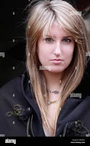 teenage girl with pouting expression in black long hair Stock Photo