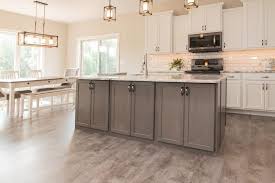 Glossy White Tile Backsplash Brown Luxury Vinyl Plank Flooring Vinyl Plank Flooring Flooring Trends Luxury Vinyl Plank Flooring