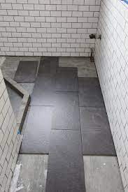 Lay the tiles out on the floor to determine exactly where you want to put them. What S The Best Tile Layout For My Bathroom Straight Or Staggered Grey Bathroom Floor Tile Layout Bathroom Flooring