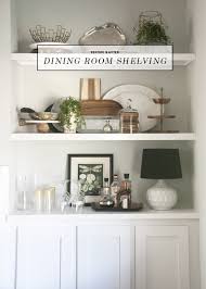 A marigot medium chandelier lights a brown oval dining table surrounded by white bamboo dining chairs. Before After Dining Room Built In Open Shelving Earnest Home Co