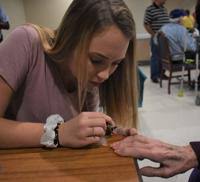 More than a manicure: VHS cosmetology students give their time, friendship  to nursing home residents