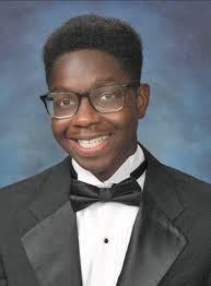 A cap, gown and red roses in his chair'