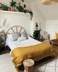 The tropical primary bedroom features a white skirted lounge chair and upholstered bed with cushioned stools on its end that sit on a vintage area rug. The Top 88 Bedroom Storage Ideas Interior Home And Design