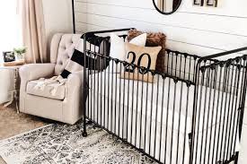 Black and white moon wallpaper and an antique crib make a perfect gender neutral bohemian style baby room. The Best Gender Neutral Nursery Inspiration