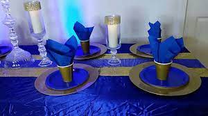 Lining the length of the table, silver dollar eucalyptus and gold tapered candles add simple, elegant color to this formal table setting. Diy Dollar Tree Royal Blue And Gold Table Setting Prince Baby Shower Royal Blue And Gold Wedding Youtube