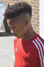 Who doesn't want to don awesome cuts at a a short, buzzed haircut with just a few detailed lines creates an awesome style. Black Boys Haircuts And Hairstyles 2021 Update Menshaircuts Com Boys Haircuts Black Boys Haircuts Cool Boys Haircuts