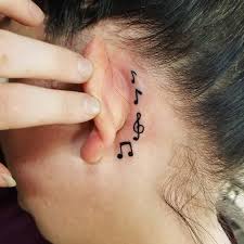 A swallow bird tattoo design with music note on the chest of women. 41 Cool Behind The Ear Tattoos For Women Stayglam