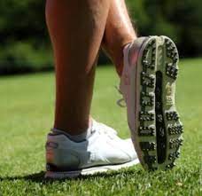 The club face is outside her hands as starts to take the club back. Ultimate Guide To Golf Shoes For Women Must Read Before You Buy