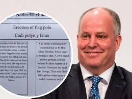 The Welsh translation of this sign outside town hall tells Tory politician  to stick Union Jack flag up his bum