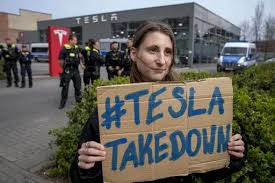 Protesters rebelling against Elon Musk's purge of US government swarm Tesla  showrooms | The Yazoo Herald