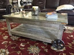 An antique indian carved wooden grinding wheel made into a coffee table. Antique Wheel And Gray Coffee Table Red Miter Furniture