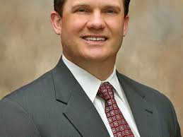 John Riley delays retirement to stay