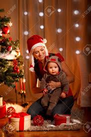 Smiling Mother With Lovely Baby Sitting Near Christmas Tree Stock Photo Picture And Royalty Free Image Image 11374652