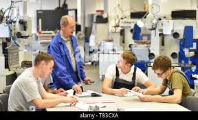 Group Of Young People In Technical Vocational Training With Teacher Stock Photo Alamy