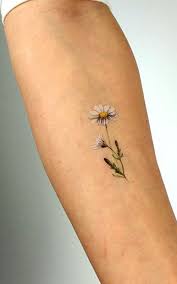 Instead of a massive floral design, consider a creeping colored tattoo of flower stems and petals. 35 Small Flower Tattoos For Girls