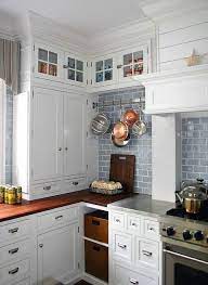 Kitchen with white counter top and bluish gray cabinets against tile backsplash. Love This White Cabinets Blue Subway Tile Butcher Block Darker Stained I Think I D Like Sligh Kitchen Design Kitchen Cabinet Design Kitchen Inspirations