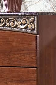 The fairbrooks estate bedroom collection features warm finishes and ornate detailing to create a furniture collection that is sure to enhance your bedroom decor with an inviting traditional design. Ashley Fairbrooks Estate B105 King Size Bedroom Set 3pcs In Reddish Brown B105 68 66 99 92 2