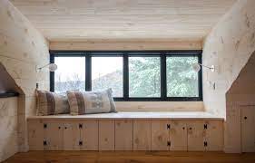 The room has pristine white flooring and glazed windows framing an expansive view. 20 Cozy Window Seat Ideas Inspiring Seating For Any Home