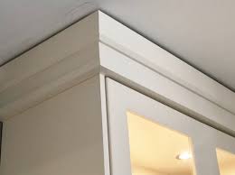 Use a nail gun to nail through the boards into the cabinets and ceiling. Crown Molding Avondale Kitchens