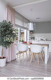 Perfect for bedroom, living room, dining room, and kitchen. White Chairs At Table In Modern Dining Room Interior With Plant And Pink Drapes Real Photo Canstock