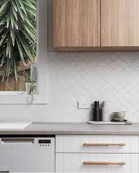 Timeless kitchen includes white shaker cabinets, white quartz countertops and white square backsplash tiles with gray grout. Coral Bay Matt White Fish Scale Tile White Kitchen Splashback White Kitchen Tiles Kitchen Backsplash Designs