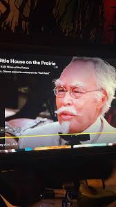Sat in Mcdonalds having our exciting tea or nuggets, while looking at KfC  next door and it occurred to us that the Colonel appears to resemble a  famous Australian artist. Can you