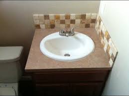 It's made from solid and engineered wood with a white granite countertop around a ceramic undermount sink, plus a matching backsplash to protect your walls. Bathroom Vanity Backsplash Youtube