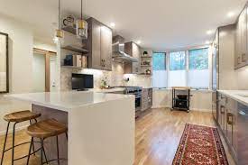 Grey Shaker Cabinetry With Waterfall Edge Kitchen And Bath Design Herringbone Tile Backsplash Kitchen Remodel
