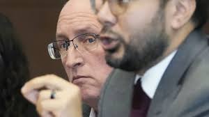 The father of a mass shooting suspect stands trial for helping him get a  gun license