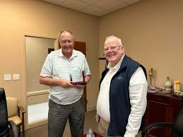 Putnam County 911 board chairman Bob Duncan presents board member Jerry  Abston with a plaque in appreciation for 15 years service