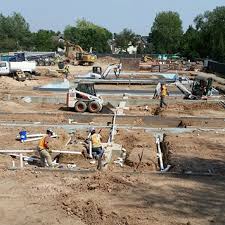 A construction engineer surveying his steel frame building with pride. Residential Commercial Plumbing New Construction Neuworks Mechanical Inc