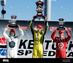 From left, Dario Franchitti, of Scotland; Ed Carpenter; and Scott Dixon, of  New Zealand, stand on podium after the Kentucky 300 IndyCar Series auto  race Sunday, Oct. 2, 2011, in Sparta, Ky.