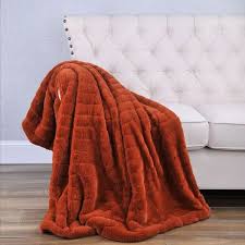 The throw blanket and rug add pops of color amidst the white walls. Yvonne Throw In 2021 Orange Blanket Burnt Orange Throw Blanket Burnt Orange Blanket